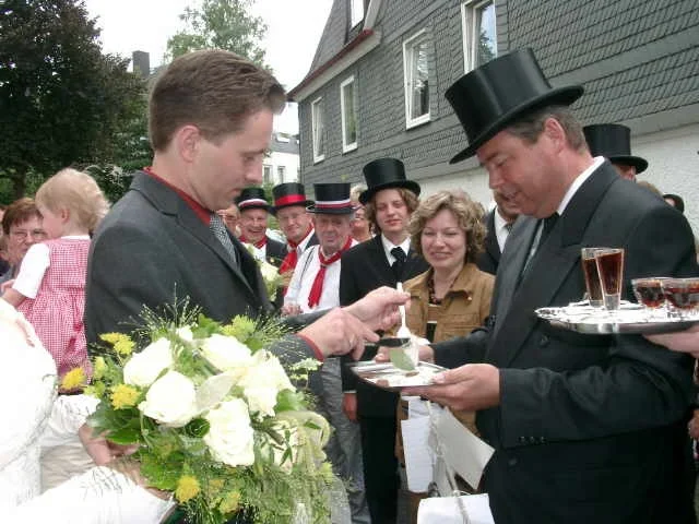 Die 1972 gegründete Heringskapelle aus Freienohl reicht dem Brautpaar auf einem Silbertablett einen Hering zum Essen.