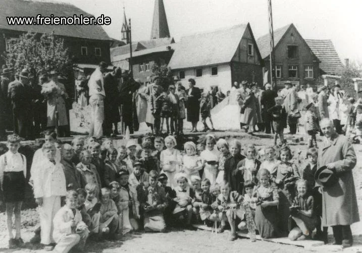 Gäste und Schulkinder mit Lehrer Demmel bei der Grundsteinlegung am 26. Mai 1955.